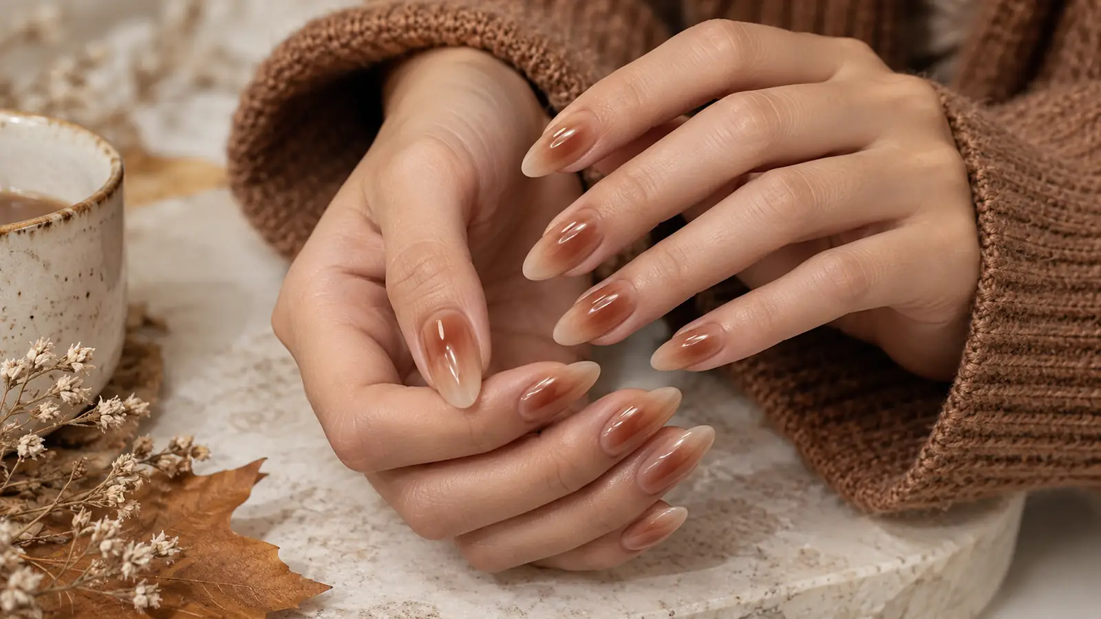Caramel aura manicure fading into milky beige almond nails